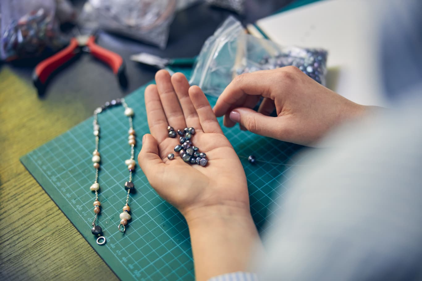 Artesana elaborando bisutería católica a mano